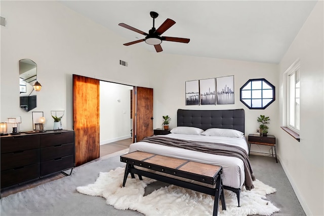 carpeted bedroom featuring ceiling fan and high vaulted ceiling