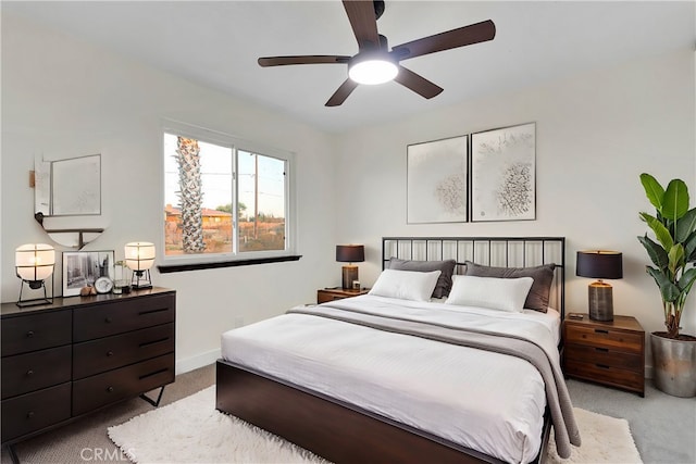 bedroom featuring ceiling fan and light carpet