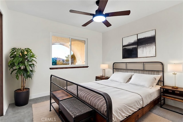 bedroom featuring light colored carpet and ceiling fan