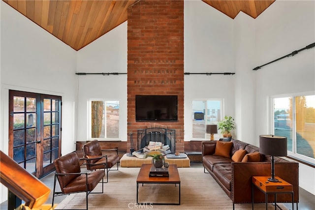 living room with french doors, wooden ceiling, high vaulted ceiling, and a fireplace