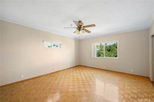 empty room with ceiling fan, a textured ceiling, light parquet floors, and ornamental molding