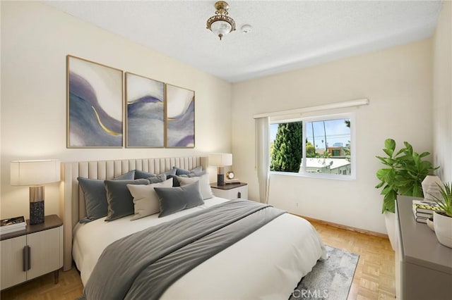 bedroom with light parquet flooring