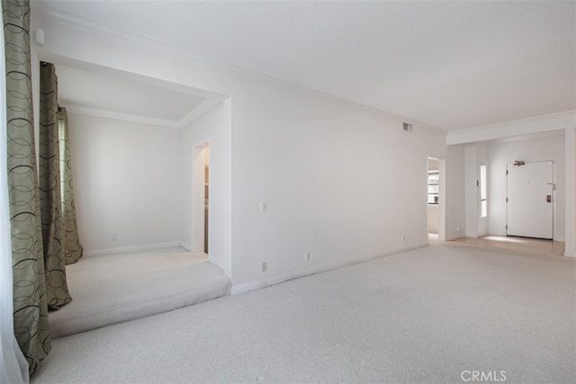 carpeted spare room featuring ornamental molding