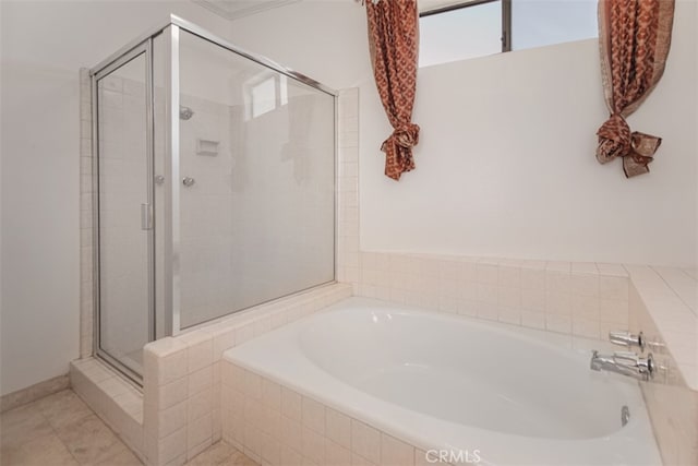 bathroom featuring shower with separate bathtub