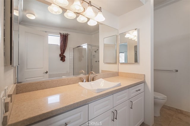 bathroom featuring toilet, vanity, tile patterned floors, crown molding, and a shower with shower door