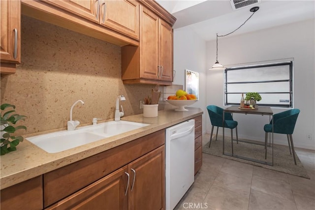 kitchen with decorative light fixtures, decorative backsplash, dishwasher, and sink