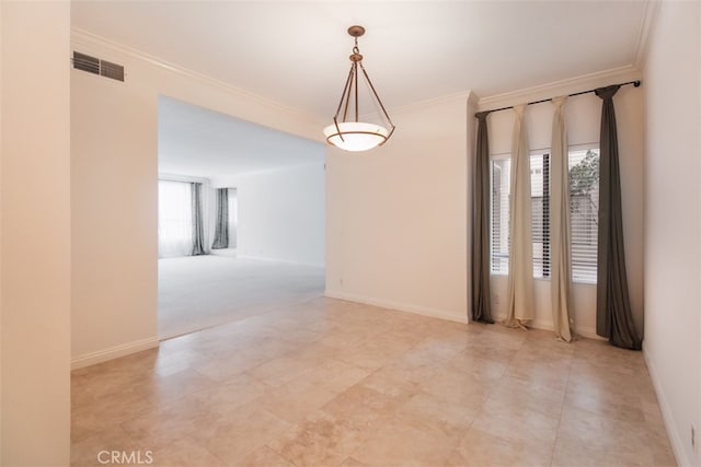 empty room featuring crown molding