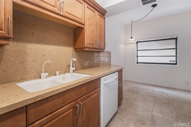 kitchen with tasteful backsplash, dishwasher, hanging light fixtures, light stone counters, and sink