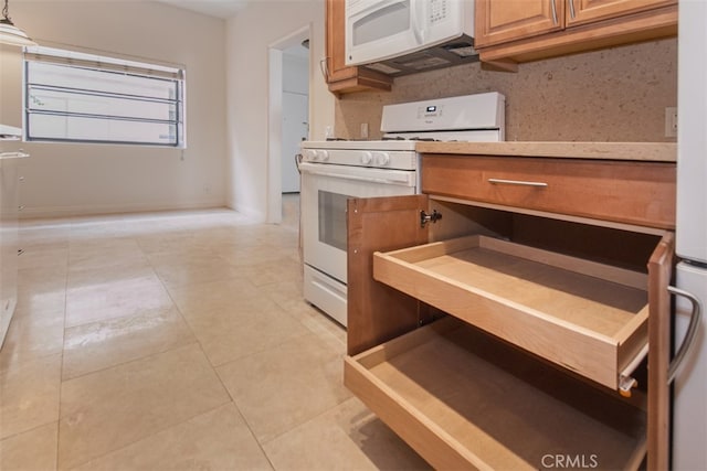 kitchen featuring light tile patterned floors, decorative backsplash, and white appliances