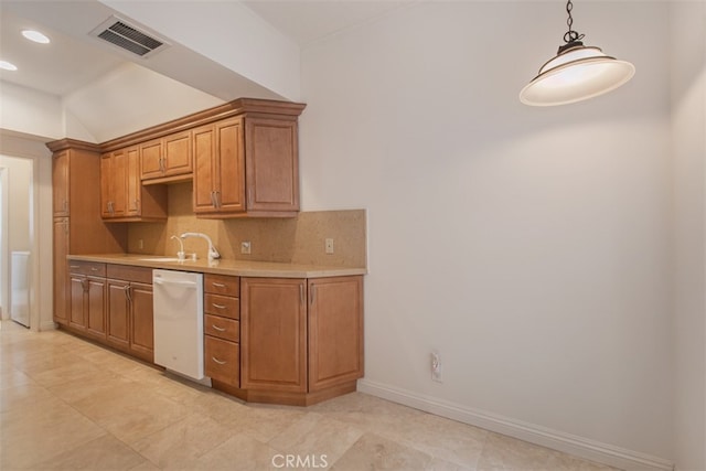 kitchen featuring backsplash, dishwasher, vaulted ceiling, pendant lighting, and sink