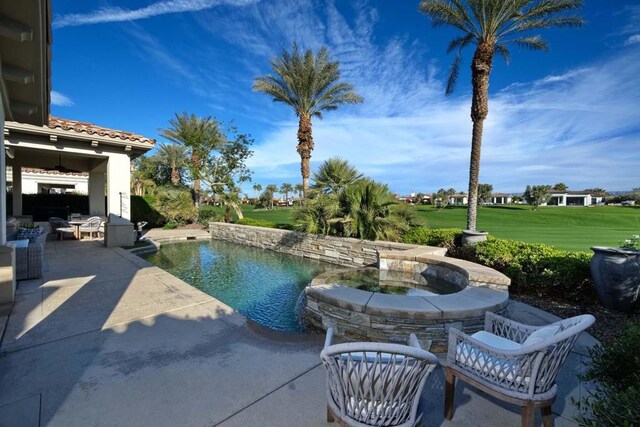 view of swimming pool with a yard and a patio