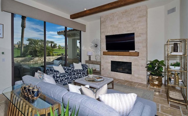 living room featuring a fireplace and beamed ceiling