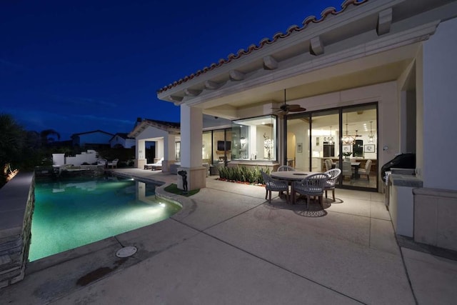 view of swimming pool with ceiling fan and a patio area