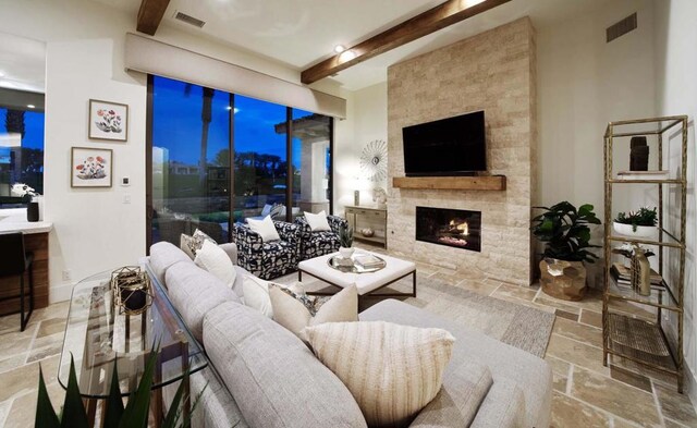 living room featuring a fireplace and beamed ceiling