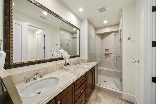 bathroom with vanity and a shower with door