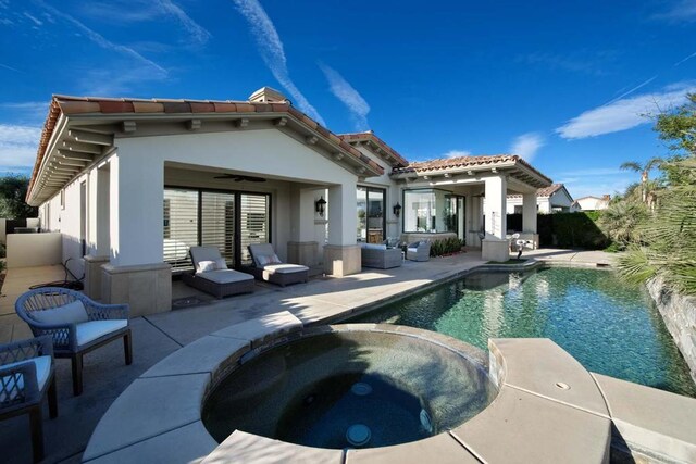 back of property with a pool with hot tub, a patio area, and ceiling fan