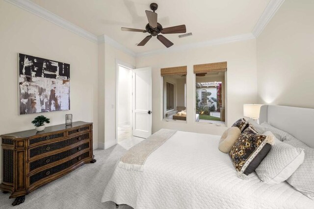 bedroom featuring ceiling fan, light colored carpet, and crown molding