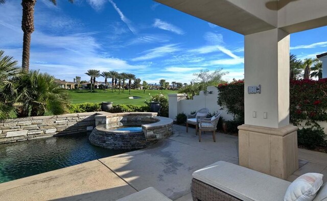 view of patio with a water view and an in ground hot tub