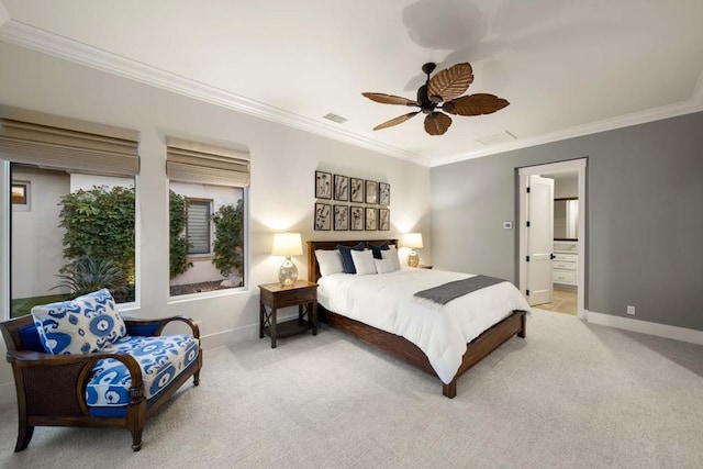 bedroom featuring ceiling fan, light colored carpet, ornamental molding, and ensuite bath