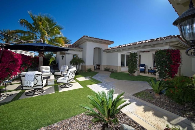 back of property with a patio area, outdoor lounge area, and ceiling fan