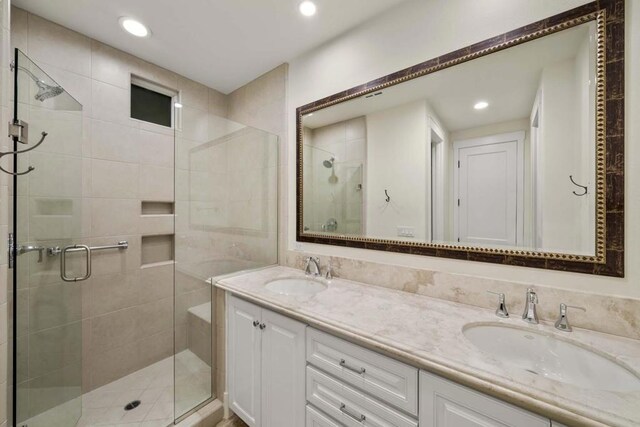 bathroom with walk in shower and vanity