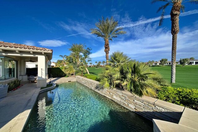 view of swimming pool featuring a patio area and a lawn