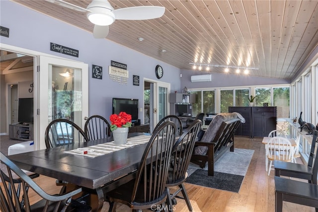 dining room featuring light hardwood / wood-style floors, wooden ceiling, a wall mounted air conditioner, track lighting, and french doors