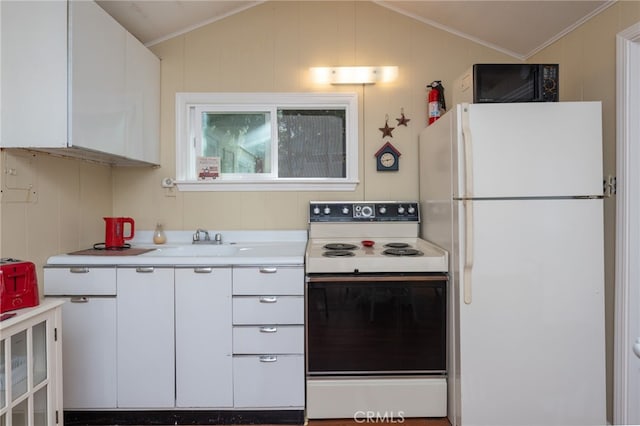 kitchen with white appliances, white cabinets, and lofted ceiling