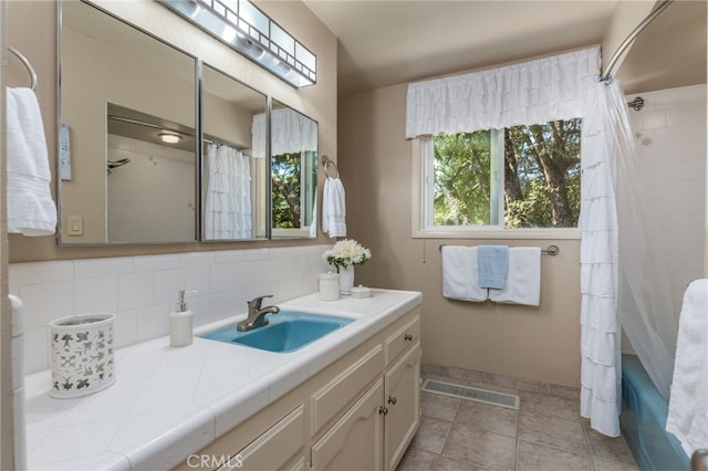 bathroom featuring shower / tub combo, tasteful backsplash, and vanity