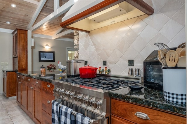 kitchen with dark stone countertops, vaulted ceiling with beams, custom range hood, high end stainless steel range, and wooden ceiling