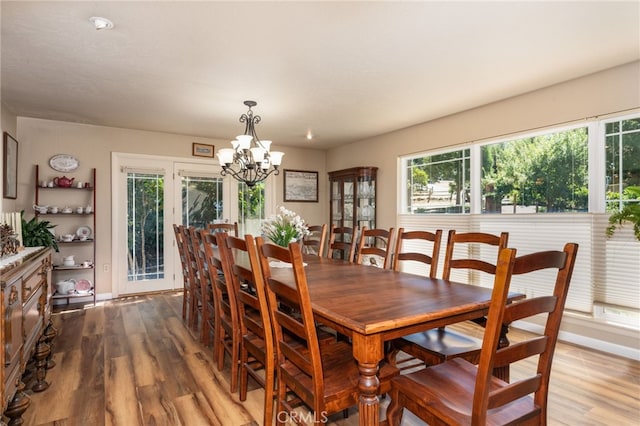 dining room with an inviting chandelier and light hardwood / wood-style flooring