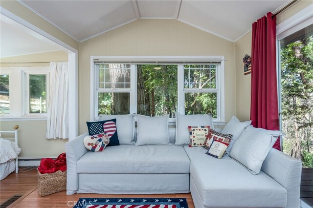 sunroom / solarium with vaulted ceiling and a baseboard radiator