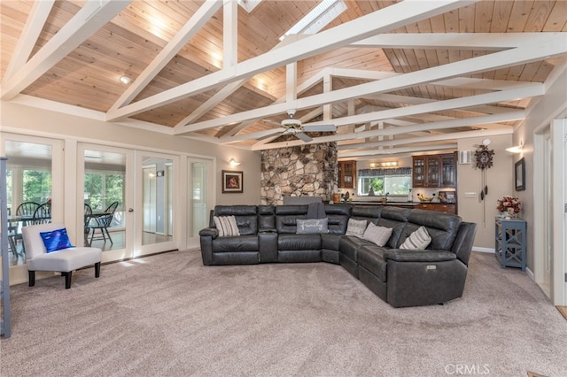 living room featuring carpet, a healthy amount of sunlight, and high vaulted ceiling