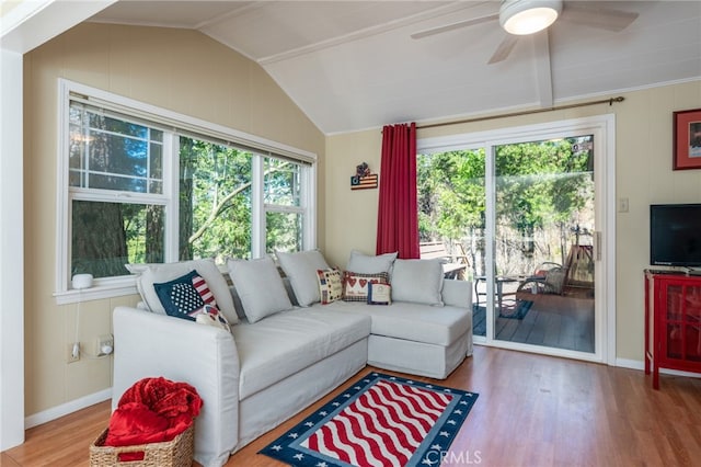 living room featuring vaulted ceiling, ceiling fan, a healthy amount of sunlight, and wood-type flooring