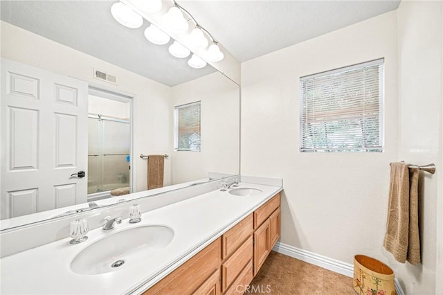 bathroom with vanity, tile patterned floors, and shower / bath combination with glass door