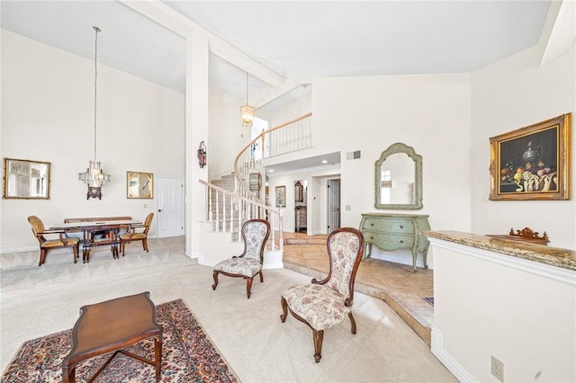 living room with carpet flooring and a towering ceiling