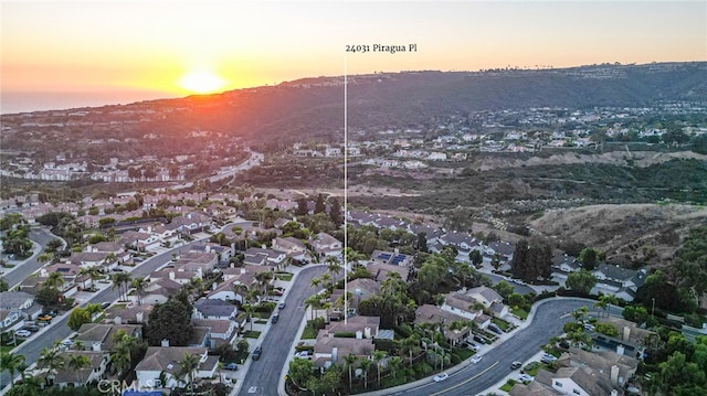 aerial view at dusk featuring a mountain view