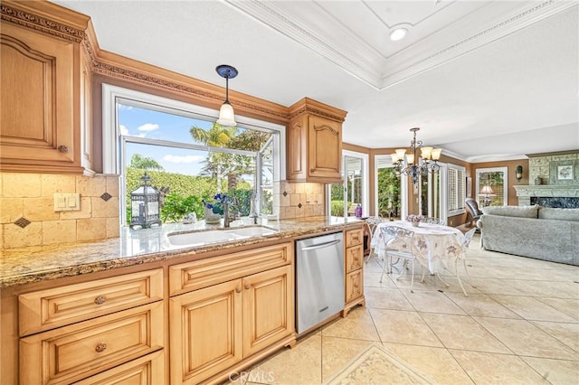 kitchen featuring tasteful backsplash, dishwasher, a fireplace, sink, and ornamental molding