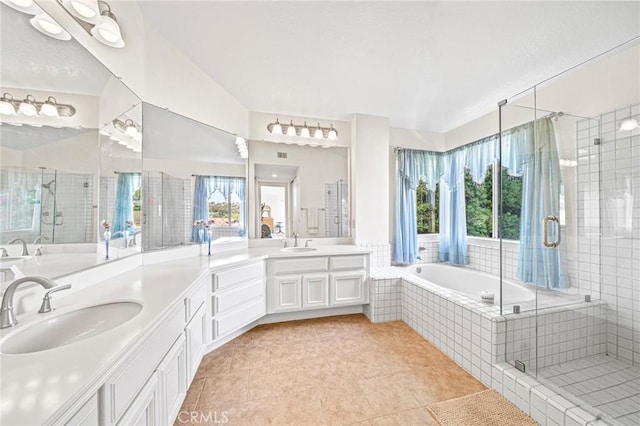 bathroom featuring separate shower and tub, vanity, tile patterned flooring, and vaulted ceiling