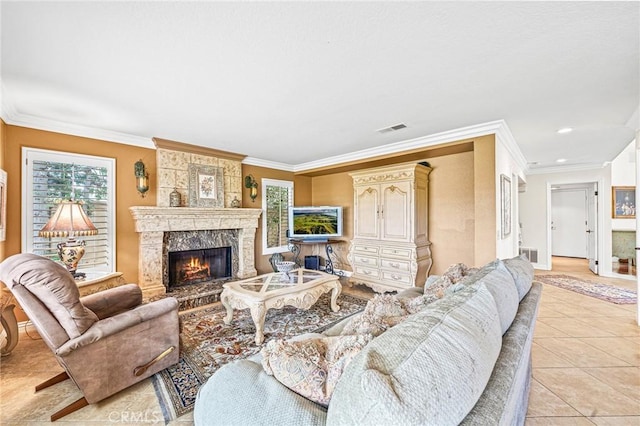 living room with light tile patterned floors, crown molding, and a fireplace