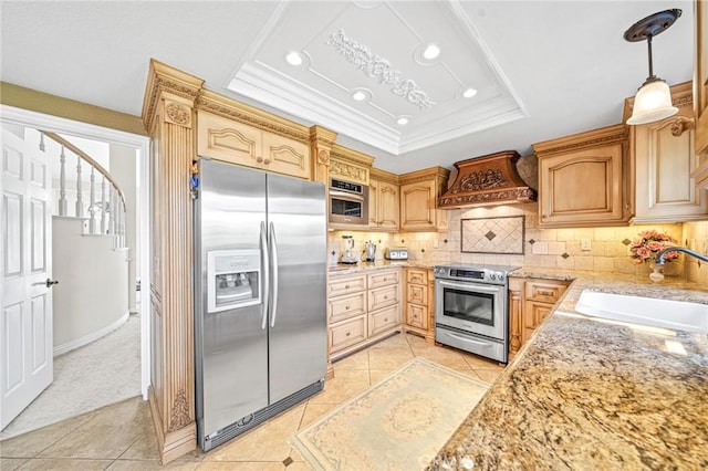 kitchen featuring custom exhaust hood, decorative backsplash, sink, a tray ceiling, and appliances with stainless steel finishes