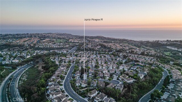 aerial view at dusk with a water view