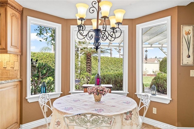 tiled dining area with an inviting chandelier