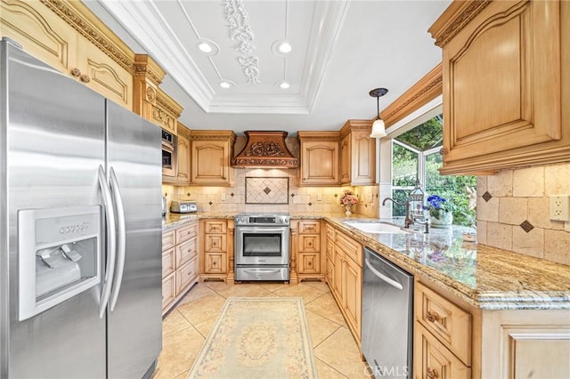 kitchen with decorative light fixtures, a raised ceiling, sink, appliances with stainless steel finishes, and custom range hood