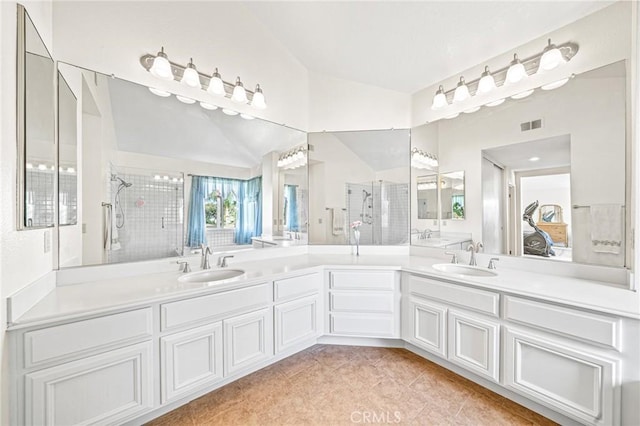 bathroom featuring walk in shower, vanity, and tile patterned flooring