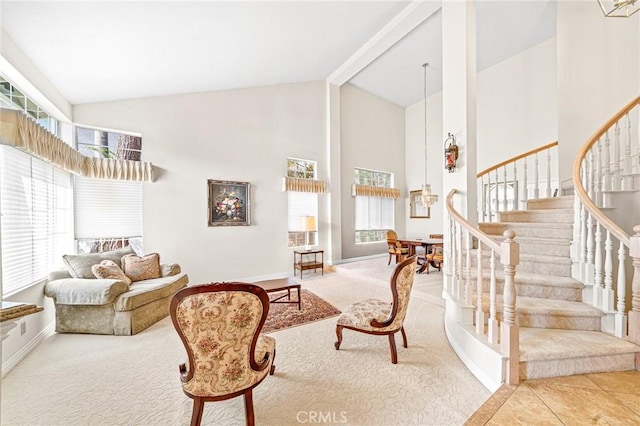 carpeted living room featuring high vaulted ceiling