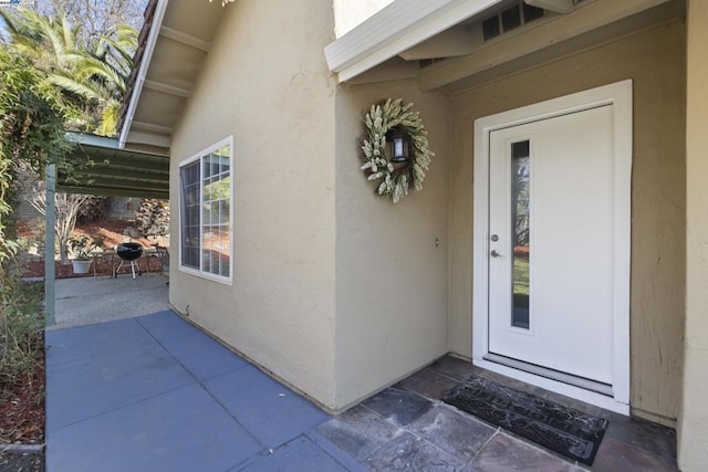 doorway to property with a patio area