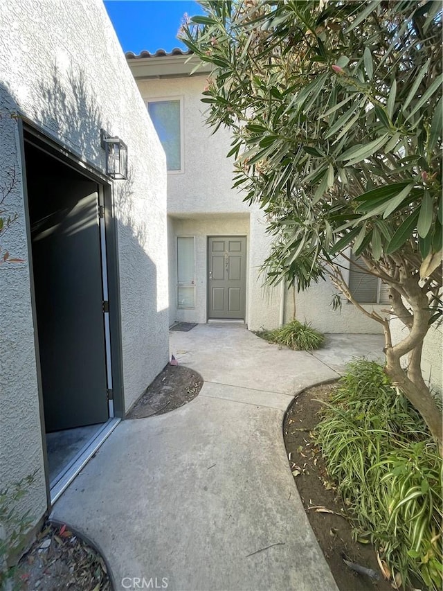 doorway to property with a patio area