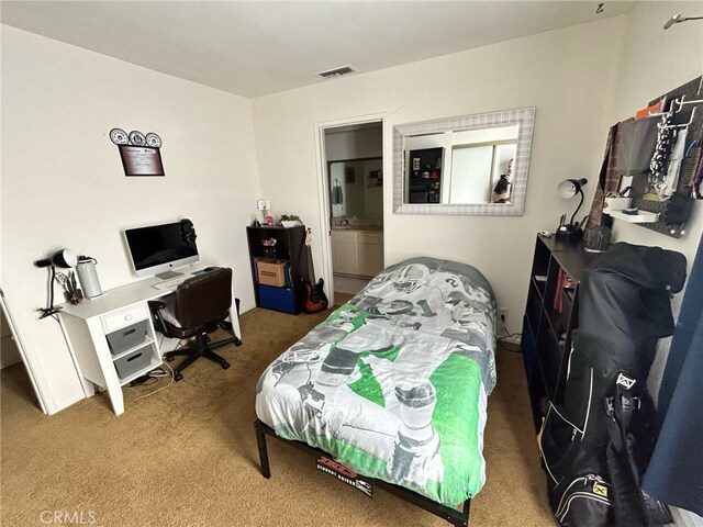 bedroom featuring carpet flooring and connected bathroom