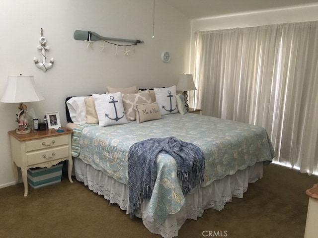 bedroom featuring dark colored carpet